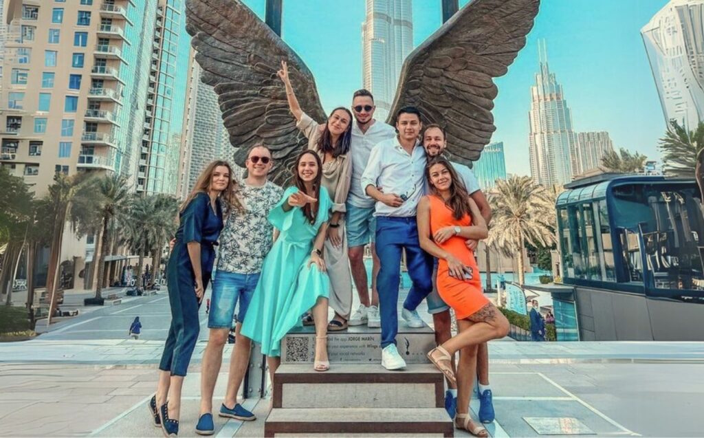 Group photoshoot in Dubai with flying dresses and cityscape background"